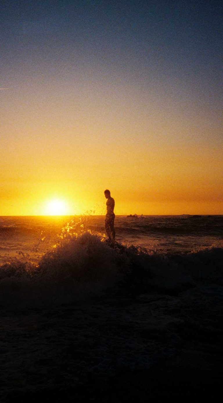 photo d'un homme à la mer en clair obscur devant un coucher de soleil avec une vague par MITHRIL PRODUCTION production vidéos et photos